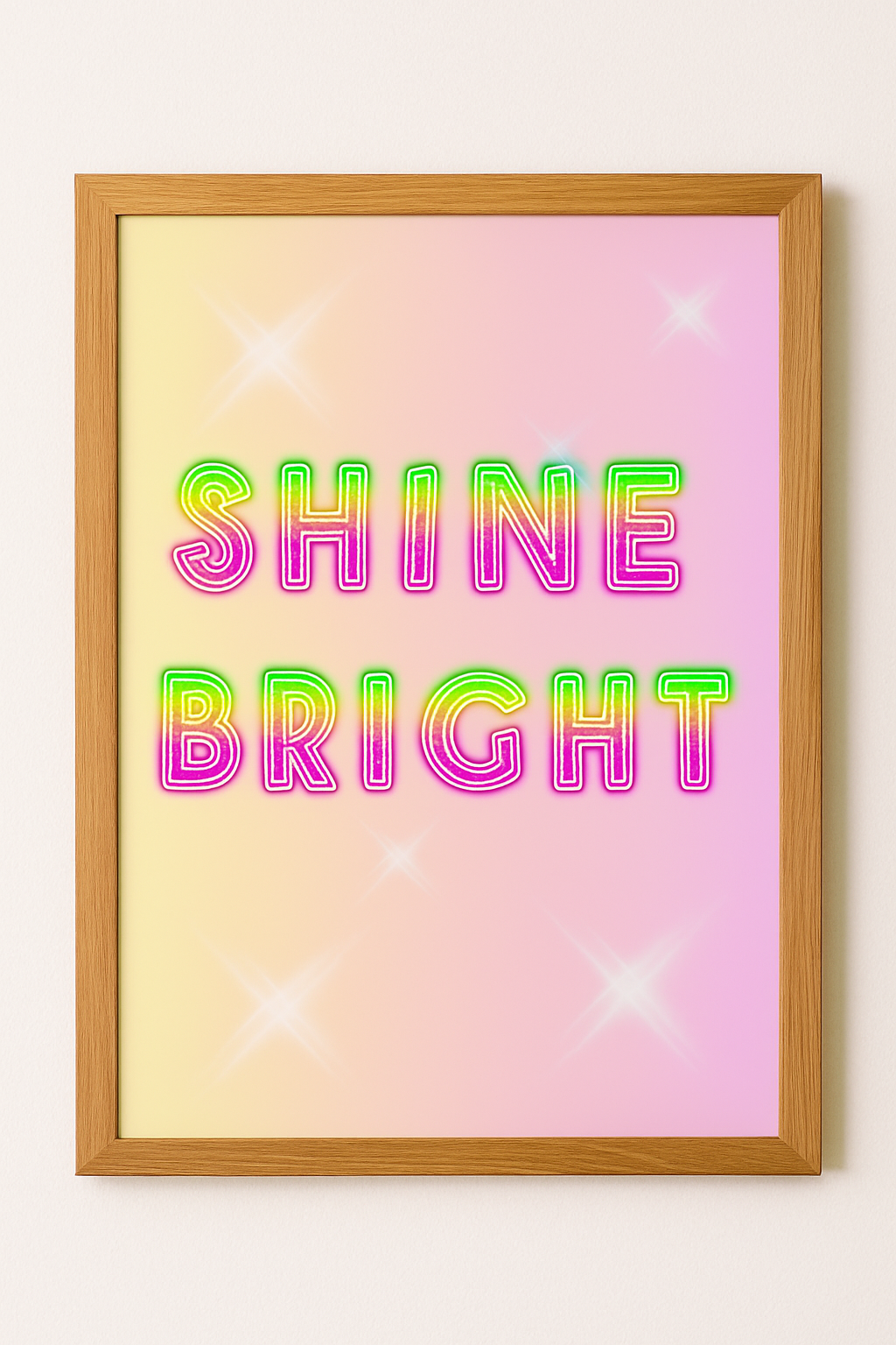 Shine Bright neon-style wall art print in a natural oak frame with a pink and yellow gradient background and glowing lettering